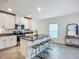 Kitchen island featuring a sink, granite countertop with seating, and view of the dining area at 11015 High Noon Trl, Parrish, FL 34219