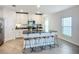 Open concept kitchen with granite island, white cabinets, stainless appliances, and casual dining area at 11015 High Noon Trl, Parrish, FL 34219
