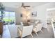 Living room features neutral furniture, a ceiling fan, and sliding doors that lead to the backyard at 11015 High Noon Trl, Parrish, FL 34219
