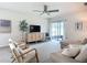Living room with ceiling fan, neutral furniture, sliding glass doors to the patio, and an accent table at 11015 High Noon Trl, Parrish, FL 34219