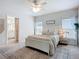 Main bedroom with ceiling fan, ensuite bathroom, and windows providing lots of natural light at 11015 High Noon Trl, Parrish, FL 34219