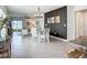 Open floor plan with kitchen, dining, and living areas with lots of natural light and tile floors at 11015 High Noon Trl, Parrish, FL 34219