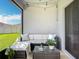 Covered patio with comfortable seating, string lights and green backyard views at 11015 High Noon Trl, Parrish, FL 34219