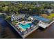 Aerial view of community pool and tennis courts surrounded by palm trees, with canal access at 11367 Perico Isle Cir, Bradenton, FL 34209