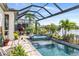 Screened-in pool and patio area with lush landscaping and peaceful views at 11367 Perico Isle Cir, Bradenton, FL 34209