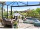 Screened-in lanai featuring a relaxing hot tub overlooking a serene pond at 11367 Perico Isle Cir, Bradenton, FL 34209