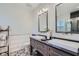 Modern bathroom featuring dual vanities, square sinks, decorative tile, and stylish lighting fixtures at 11367 Perico Isle Cir, Bradenton, FL 34209