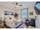 Comfortable bedroom featuring wood floors, a plush bed, and a relaxing sitting area near a bright window at 11367 Perico Isle Cir, Bradenton, FL 34209