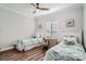Cozy bedroom with twin beds, matching linens, and a bright window with shutter-style blinds at 11367 Perico Isle Cir, Bradenton, FL 34209