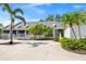 Community clubhouse featuring lush palm trees and nearby parking at 11367 Perico Isle Cir, Bradenton, FL 34209