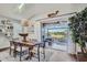 Coastal dining room with wood table, area rug, and patio view at 11367 Perico Isle Cir, Bradenton, FL 34209