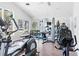 Bright gym area with lots of equipment and natural light from large windows overlooking the outdoors at 11367 Perico Isle Cir, Bradenton, FL 34209