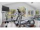 Fitness center featuring treadmills, rowing machine, weights and windows at 11367 Perico Isle Cir, Bradenton, FL 34209