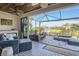 Inviting screened lanai with fireplace, lake views, seating area, and inground hot tub at 11367 Perico Isle Cir, Bradenton, FL 34209