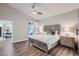 Spacious bedroom with vaulted ceilings, ceiling fan, wood-look floors, and access to outdoor patio at 11367 Perico Isle Cir, Bradenton, FL 34209