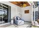 Covered outdoor patio with comfortable seating, fan and charming decor at 11367 Perico Isle Cir, Bradenton, FL 34209