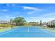 Community tennis court and pond surrounded by well-maintained landscaping at 11367 Perico Isle Cir, Bradenton, FL 34209
