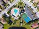 Aerial view of community amenities showcasing pool, playground, and tennis courts at 11455 52Nd E Ct, Parrish, FL 34219