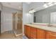 Bright bathroom with double vanity sinks, tile floor, and glass enclosed shower at 11455 52Nd E Ct, Parrish, FL 34219