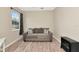 This cozy bedroom has a comfortable couch, a window, and hardwood floors at 11455 52Nd E Ct, Parrish, FL 34219