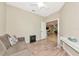 Relaxing bedroom area features sofa, desk, and decorative wood-look flooring at 11455 52Nd E Ct, Parrish, FL 34219