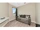 Cozy bedroom features a comfortable sofa, a window with natural light, and hardwood floors at 11455 52Nd E Ct, Parrish, FL 34219