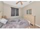 Well-lit bedroom features wood-look floors, ceiling fan, and comfortable furniture for a cozy and inviting space at 11455 52Nd E Ct, Parrish, FL 34219