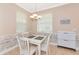 Cozy dining area with a white table and chairs, bright windows and decorative wall paneling at 11455 52Nd E Ct, Parrish, FL 34219
