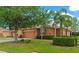 Exterior home view featuring a two-car garage, mature landscaping, and lovely curb appeal at 11455 52Nd E Ct, Parrish, FL 34219