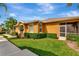 Home exterior with manicured lawn, shrubs, and screened patio at 11455 52Nd E Ct, Parrish, FL 34219
