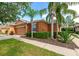 Exterior showcasing the garage, landscaping, and brown color palette of the house at 11455 52Nd E Ct, Parrish, FL 34219