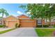 Charming single-story home with a well-manicured lawn and a two-car garage under a sunny blue sky at 11455 52Nd E Ct, Parrish, FL 34219