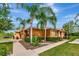 Beautiful exterior view of a home with lush landscaping and palm trees at 11455 52Nd E Ct, Parrish, FL 34219
