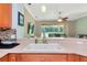 Bright kitchen with stainless steel appliances, and a view of the living room and backyard at 11455 52Nd E Ct, Parrish, FL 34219