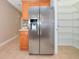 Stainless steel refrigerator in the kitchen with wood cabinets and tiled floors, with pantry at 11455 52Nd E Ct, Parrish, FL 34219