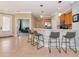 Modern kitchen bar with sleek bar stools, and stainless steel appliances, with a view to the living room at 11455 52Nd E Ct, Parrish, FL 34219