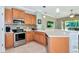 Well-equipped kitchen featuring stainless steel appliances, tile backsplash, and a convenient breakfast bar area at 11455 52Nd E Ct, Parrish, FL 34219