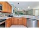 Open-concept kitchen featuring stainless steel appliances, tiled floors, and a view of the living room at 11455 52Nd E Ct, Parrish, FL 34219