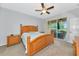 Comfortable bedroom features a ceiling fan and sliding glass doors with access to outdoor patio at 11455 52Nd E Ct, Parrish, FL 34219