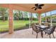 Enclosed patio with outdoor dining set and view of the landscaped backyard at 11455 52Nd E Ct, Parrish, FL 34219