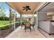 Screened patio featuring a ceiling fan and an outdoor dining set at 11455 52Nd E Ct, Parrish, FL 34219
