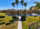 Scenic pond view with a fountain, walkway, and palm trees against a blue sky at 11455 52Nd E Ct, Parrish, FL 34219