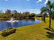 Picturesque pond with fountain and palm trees creating a serene and relaxing ambiance at 11455 52Nd E Ct, Parrish, FL 34219