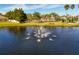 Beautiful pond with a central fountain, lush greenery, and views of community amenities at 11455 52Nd E Ct, Parrish, FL 34219