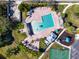 Aerial view of a community pool with sun loungers, sports courts, and playground at 11455 52Nd E Ct, Parrish, FL 34219