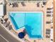 Overhead view of a pristine community pool, featuring lounge seating and lush landscaping at 116 Vista Hermosa Cir # 204C, Sarasota, FL 34242