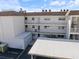 Exterior view of a condo unit featuring a private balcony and covered parking at 116 Vista Hermosa Cir # 204C, Sarasota, FL 34242