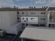 Exterior view of a condo unit featuring a private balcony and covered parking at 116 Vista Hermosa Cir # 204C, Sarasota, FL 34242