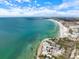 Beautiful clear turquoise ocean and shoreline with beach condos in the background at 116 Vista Hermosa Cir # 204C, Sarasota, FL 34242