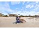 Relaxing beach scene with people enjoying the view of a beachfront property at 116 Vista Hermosa Cir # 204C, Sarasota, FL 34242